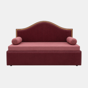 Blush velvet diwan cum bed in Dwarka with curved gold-trim headboard and pink bolster cushions on white background