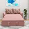 Rube sofa cum bed converted into a bed, featuring a spacious blush-pink sleeping surface, matching upholstered base, and geometric-print back cushions.