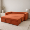 Kyro rust-orange Sofa Cum Bed converted into a bed with an extended sleeping surface and pull-out base