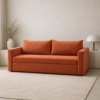 Kyro rust-orange Sofa Cum Bed displayed in a modern living room with a neutral rug and minimalist decor