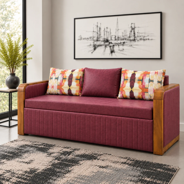 Wren maroon Sofa Cum Bed with wooden armrests and patterned cushions in a modern living room