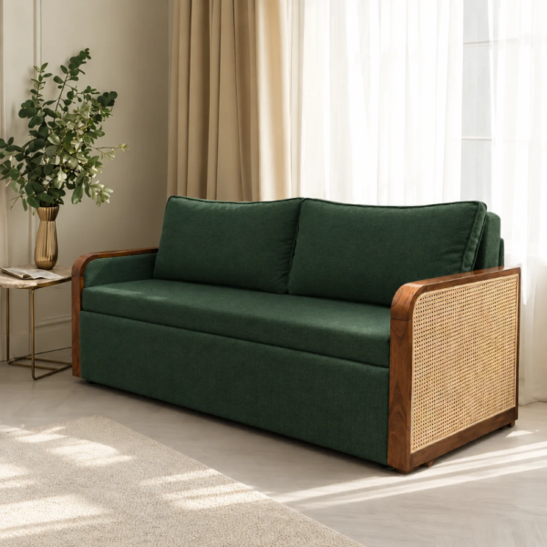 Grov green sofa cum bed with wooden frames and cane side panels in a modern living room